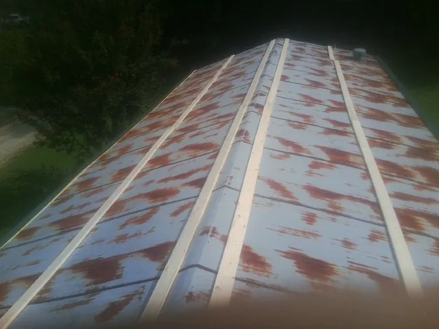 Rusted metal roof panels with new wood purlins before replacement — Storm Damage Roof Repair in Roberts by Roofing Brothers